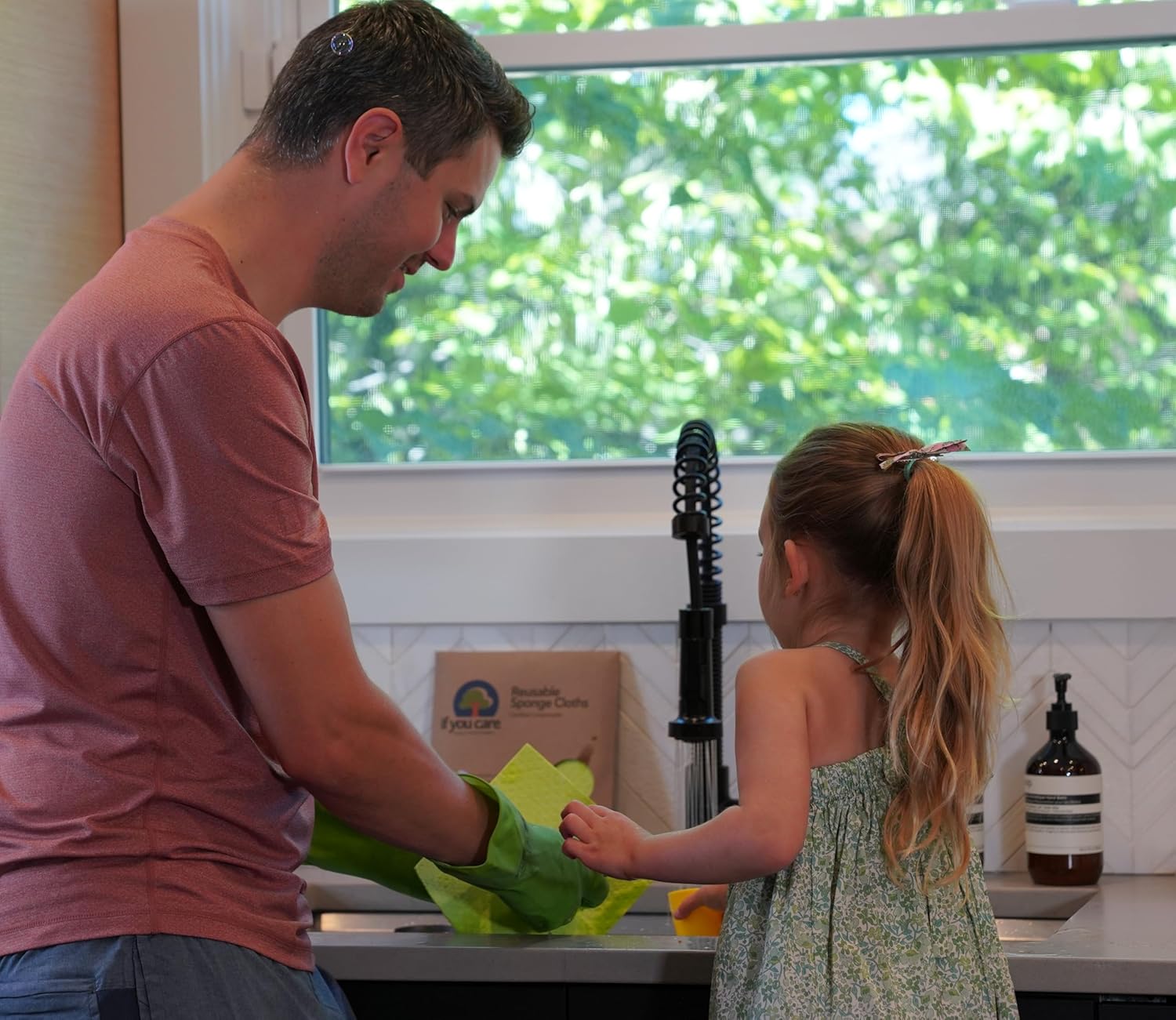 If You Care Natural Sponge Cloths being used to wipe a kitchen counter.