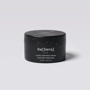 Black jar of Re[Sens] hydro ceramide cream on a light gray background